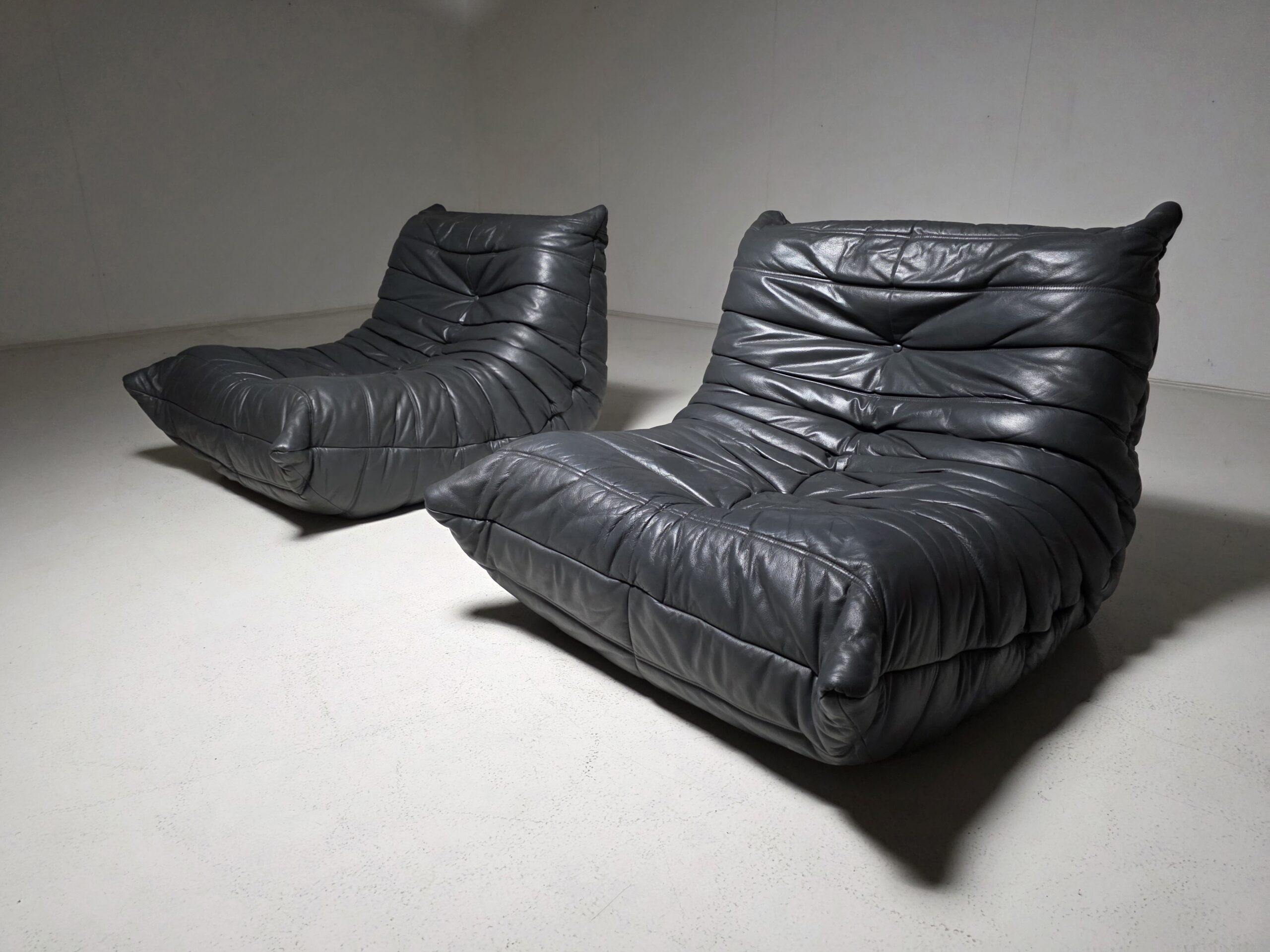 Togo chairs by Ligne Roset in grey leather
